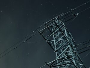 Vertical low angle shot of a transmission tower in a sky full of stars