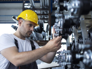 Industrial worker working at production line in factory.