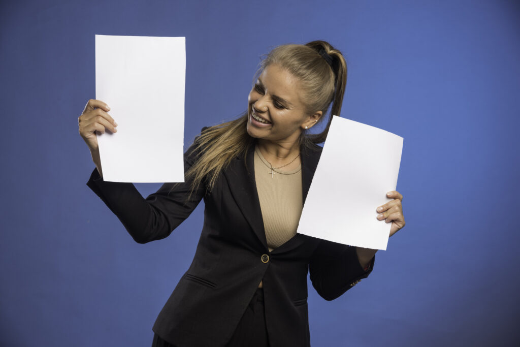 Female employee controlling documents and smiling
