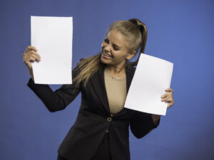 Female employee controlling documents and smiling